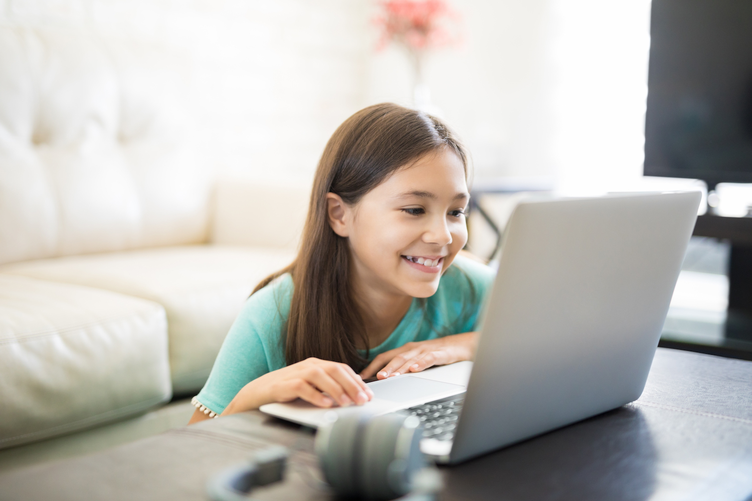 Girl coding with her Creative Coding club friends from home. 